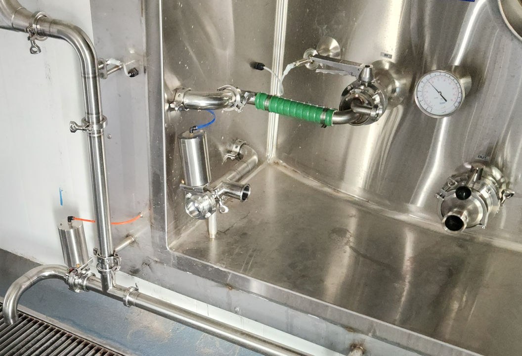 Sanitary stainless steel dairy process piping with tri-clamp fittings and a custom stainless equipment bay
